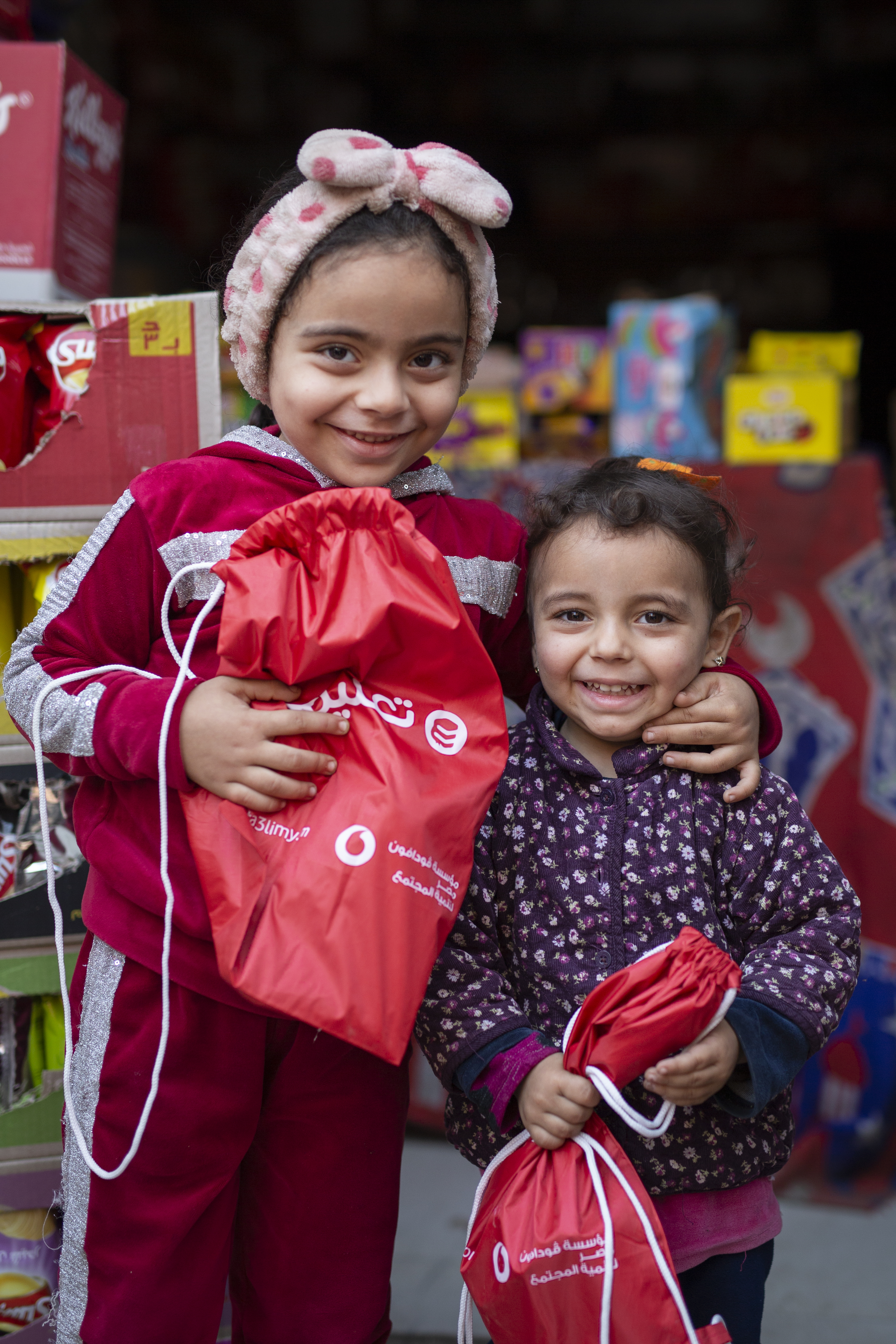 A male volunteer givin a child a gift