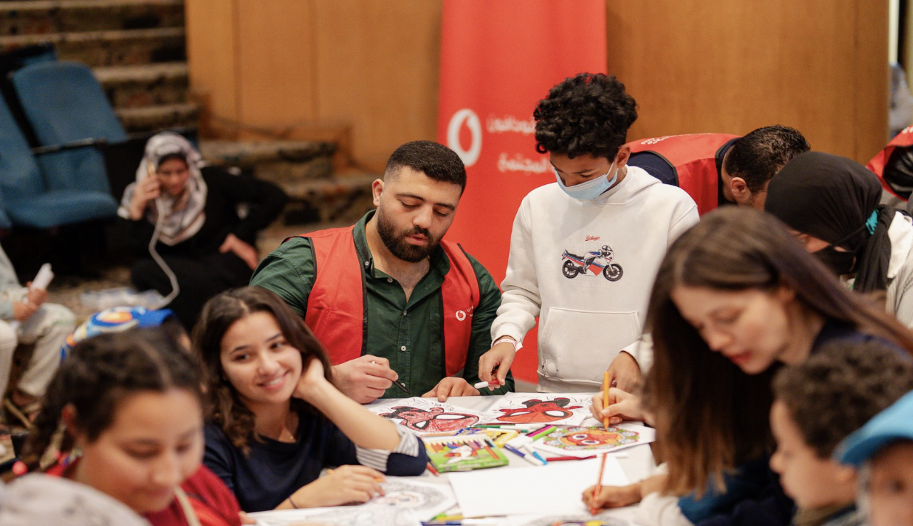 Two Volunteers hanging a gifts